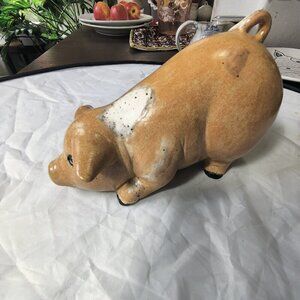 A pig figurine, wallowing in mud. Handpainted and very Realistic with mud spots